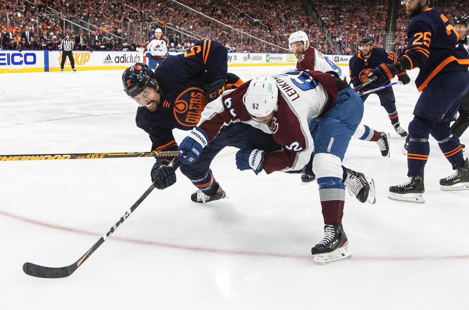 Colorado Avalanche's Artturi Lehkonen (62) checks Edmonton Oilers' Cody Ceci (5) during the first period of Game 3 of the NHL hockey Stanley Cup playoffs Western Conference finals, Saturday, June 4, 2022, in Edmonton, Alberta. (Jason Franson/The Canadian Press via AP)