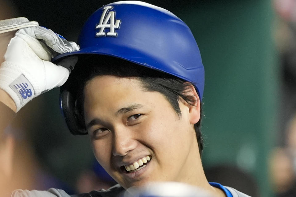 Los Angeles Dodgers designated hitter Shohei Ohtani smiles after he celebrates his solo home run during the ninth inning of a baseball game against the Washington Nationals at Nationals Park, Tuesday, April 23, 2024, in Washington. The Dodgers won 4-1. (AP Photo/Alex Brandon)