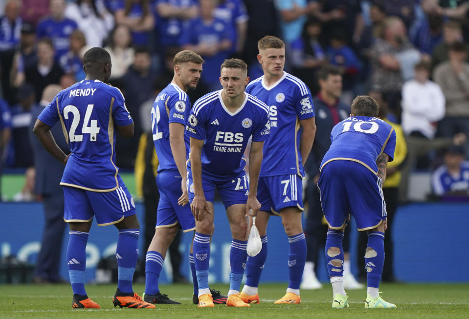 Leicester City players wait to find out the results at other matches after the English Premier League soccer match between Leicester City and West Ham United at King Power Stadium, Leicester, England, Sunday May 28, 2023. (Joe Giddens/PA via AP)