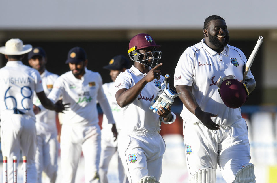 Rahkeem Cornwall (pictured right) and Kemar Roach (pictured left) of West Indies walk off the field at the end of day 2 of the 1st Test between West Indies and Sri Lanka at Vivian Richards Cricket Stadium.