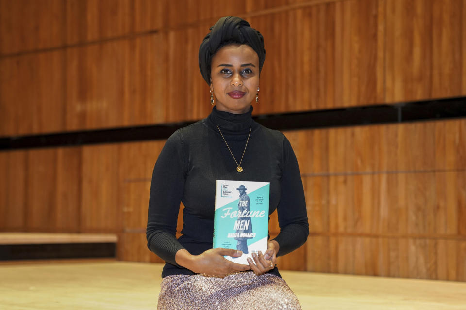 Nadifa Mohamed with her book The Fortune Men, one of the six authors shortlisted for the 2021 Booker Prize, during a photo call at the Royal Festival Hall in London, Sunday Oct. 31, 2021. (Kirsty O'Connor/PA via AP)