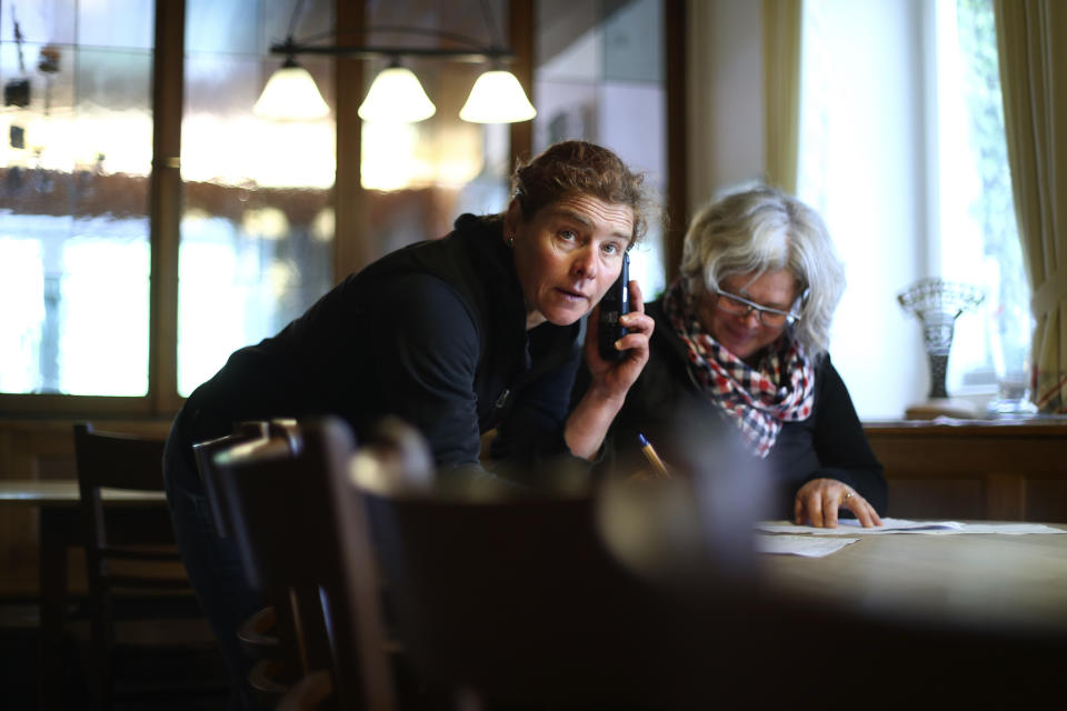 In this photo taken Friday, May 1, 2020 brewery daughters Birgit Detter, right, and her sister Iris organize the reopening of their 120 year old family brewery and traditional Bavarian restaurant in Altoetting, Germany. The 'Graminger Weissbraeu' brewery, which has been in the same family for a century, is preparing to welcome guests back to its restaurant for the first time in two months — with new rules and fears for the future. (AP Photo/Matthias Schrader)