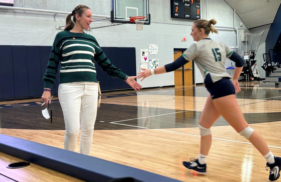 Pensacola State College head coach Patricia Gandolfo hi-fives sophomore Lyndi Bakker as she jogs off the floor during the Pirates' 3-0 sweep of Palm Beach State College on Saturday, Sept. 30, 2023 from the Ambersley and Levy Court inside Hartsell Arena.