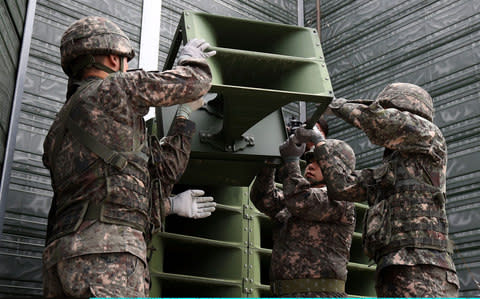 South Korean soldiers take down a propaganda loudspeakers on the border with North Korea  - Credit: Chung Sung-Jun/ Getty Images 