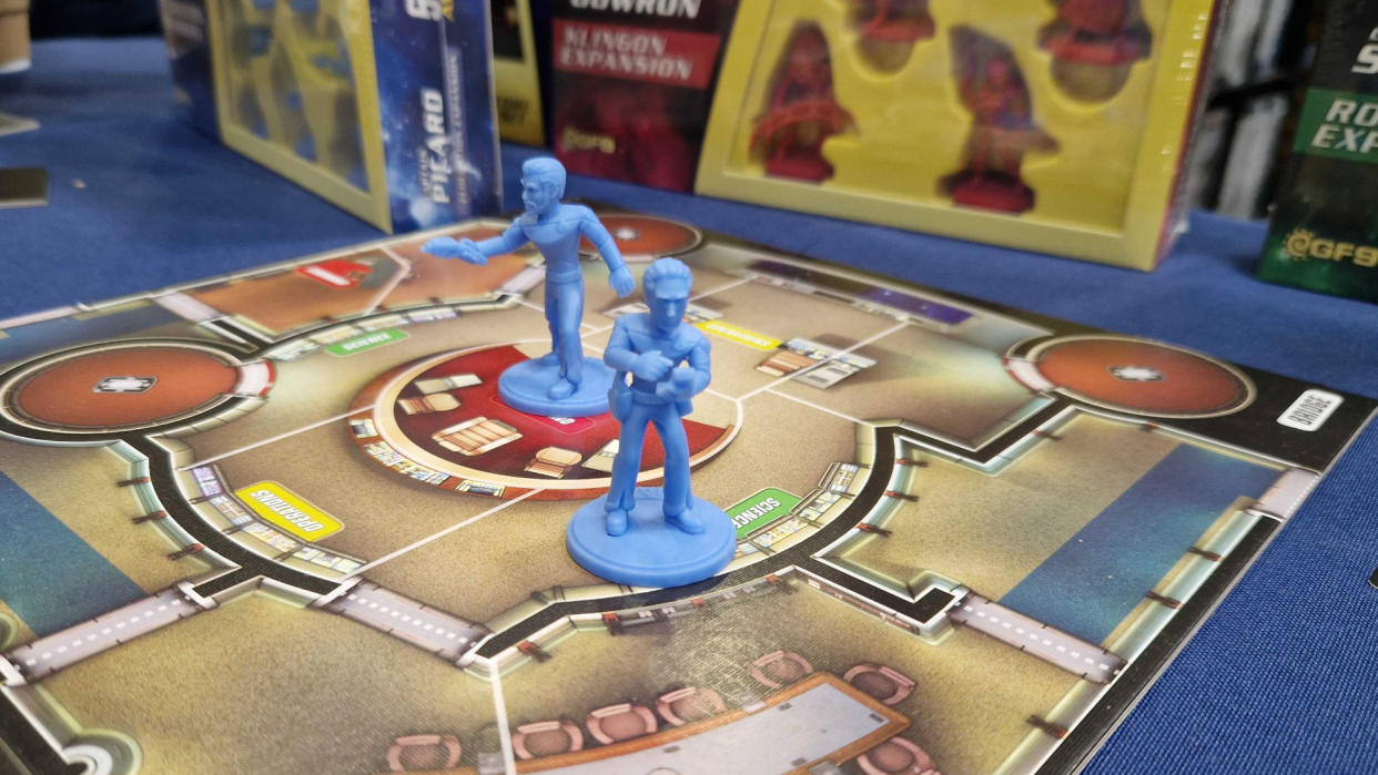  Star Trek: Away Missions models on the game's board, with boxes in the background. 