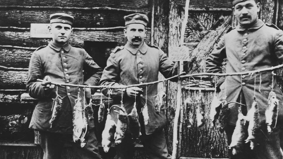 Three German soldiers display their winnings after a night of rat-catching in a Western Front trench during World War I. - Hulton Deutsch/Corbis Historical/Getty Images