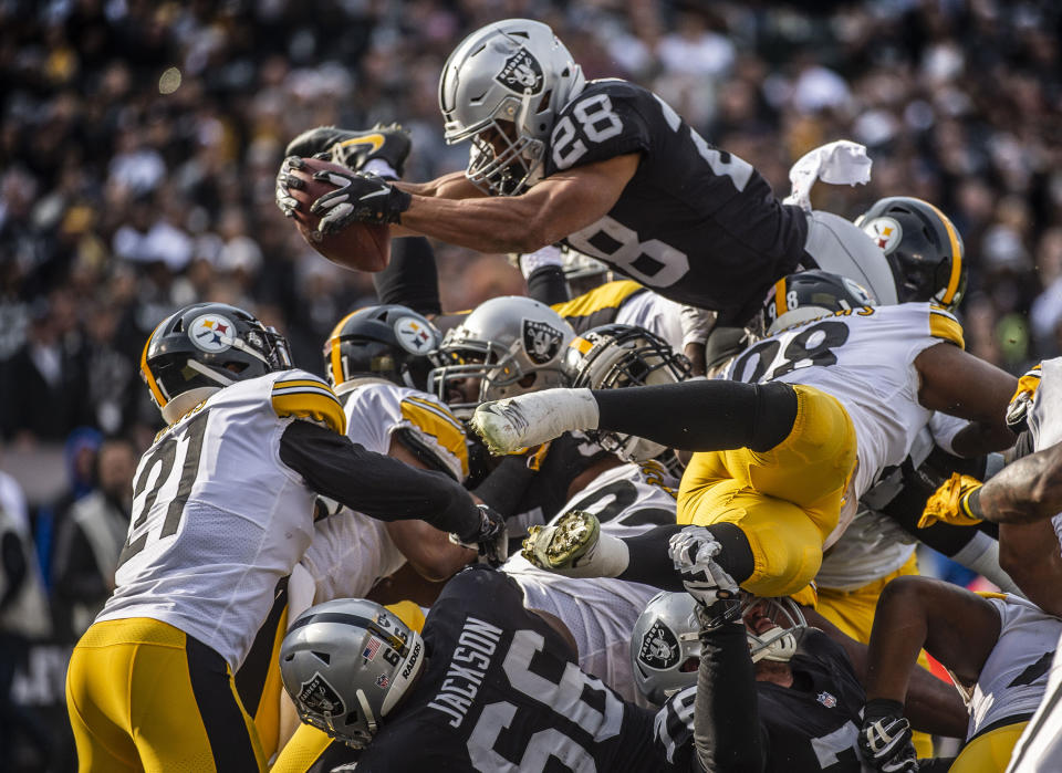 <p>Oakland Raiders running back Doug Martin (28) goes over the top for a touchdown against the Pittsburgh Steelers on Sunday, Dec. 9, 2018 at the Oakland-Alameda County Coliseum in Oakland, Calif. (Hector Amezcua/Sacramento Bee/TNS) </p>