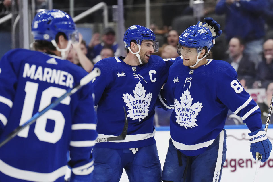 Toronto Maple Leafs forward John Tavares (91) celebrates his goal against the Dallas Stars with forward William Nylander (88) during the second period of an NHL hockey game Wednesday, Feb. 7, 2024, in Toronto. (Nathan Denette/The Canadian Press via AP)