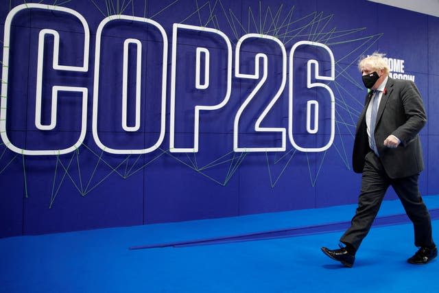 Boris Johnson in front of a Cop26 sign