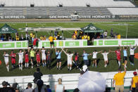 South Korea and Indonesia players join hands after their match at the Homeless World Cup, Tuesday, July 11, 2023, in Sacramento, Calif. The tournament is being held after a three-year hiatus due to the pandemic, when homeless populations surged in many U.S. cities. In Sacramento alone, it increased 68% between 2020 and 2022. (AP Photo/Godofredo A. Vásquez)