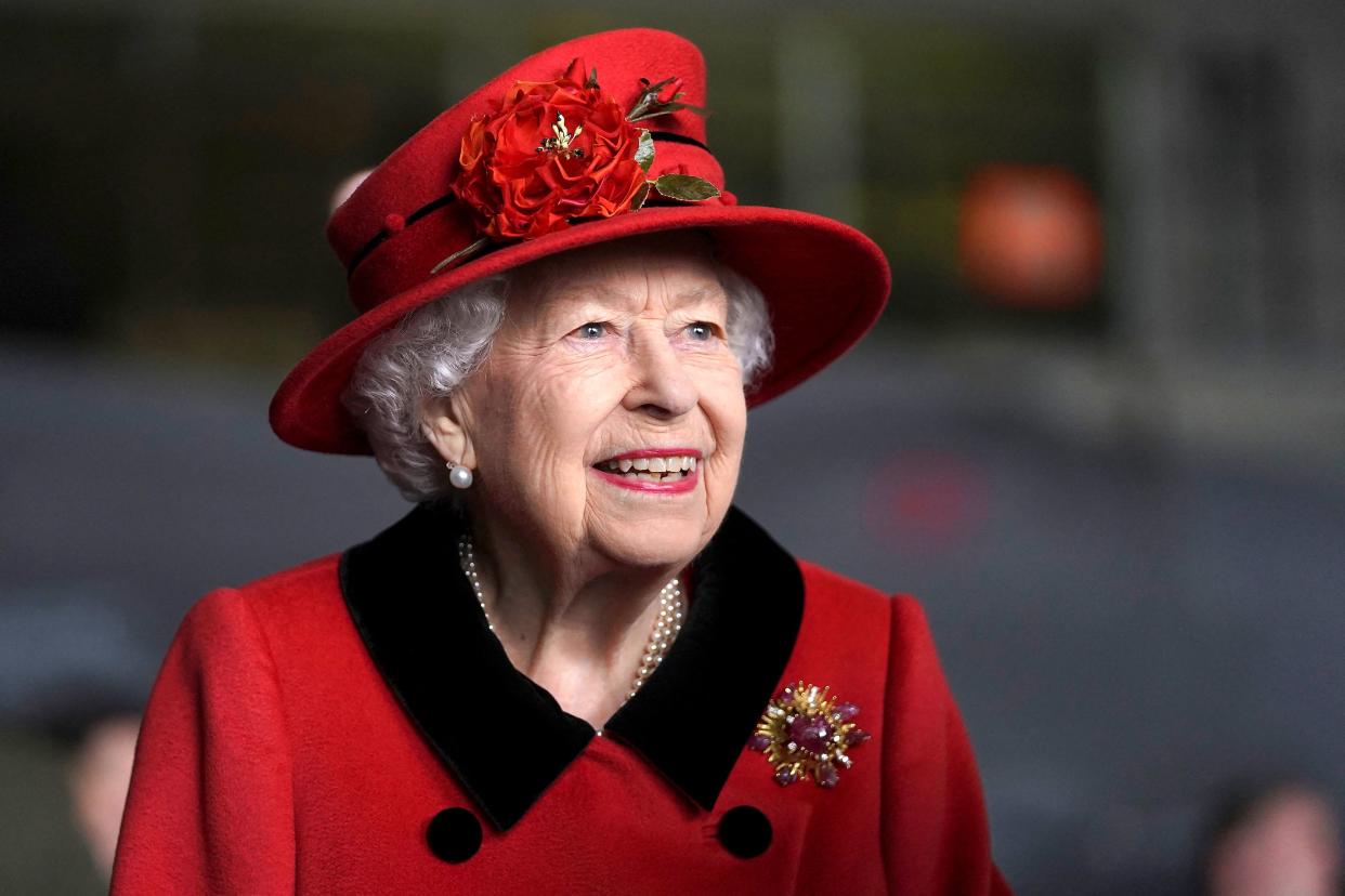 TOPSHOT - Britain's Queen Elizabeth II reacts during her visit to the aircraft carrier HMS Queen Elizabeth in Portsmouth, southern England on May 22, 2021, ahead of its maiden operational deployment to the Philippine Sea. - The aircraft carrier will embark on her first operational deployment on May 23, leading the UK Carrier Strike Group in engagements with 40 nations including India, Japan, Republic of Korea and Singapore. (Photo by Steve Parsons / POOL / AFP) (Photo by STEVE PARSONS/POOL/AFP via Getty Images)