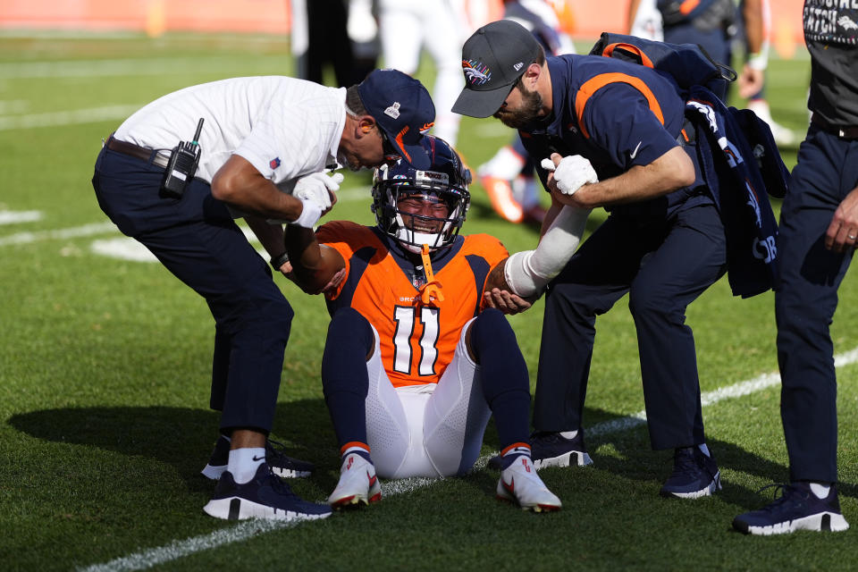 Denver Broncos wide receiver Diontae Spencer (11) is helped off the field after taking a hit against the Baltimore Ravens during the first half of an NFL football game, Sunday, Oct. 3, 2021, in Denver. (AP Photo/Jack Dempsey)