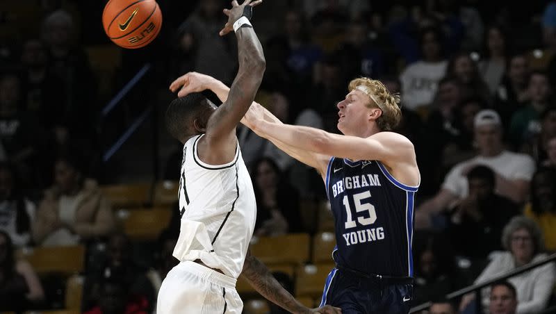 BYU guard Richie Saunders (15) passes the ball past Central Florida forward C.J. Walker, left, during the first half of an NCAA college basketball game, Saturday, Jan. 13, 2024, in Orlando, Fla.