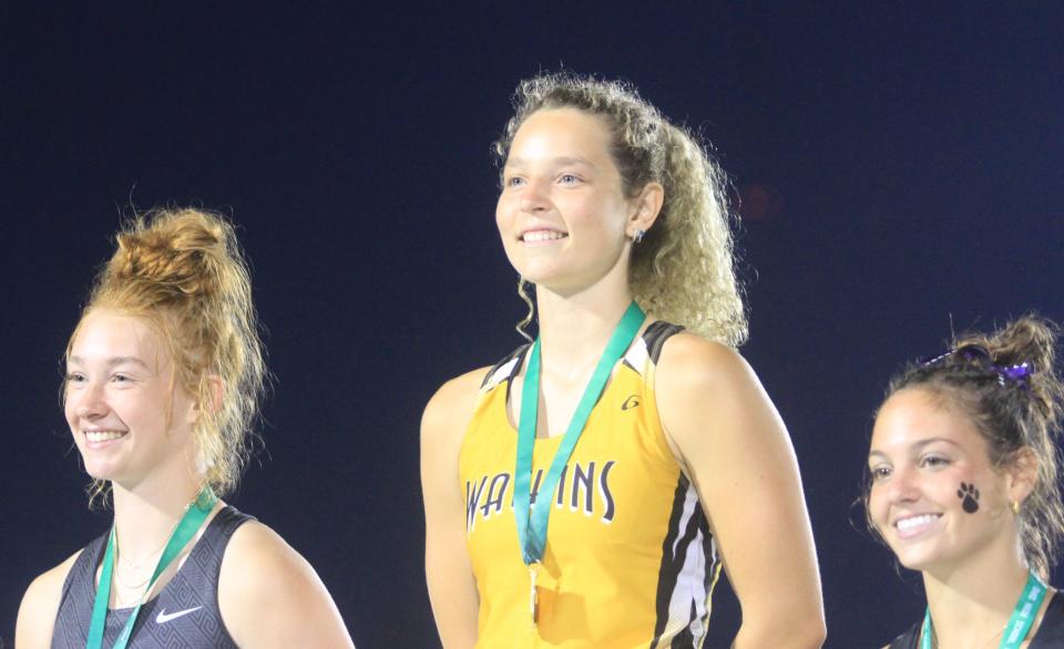 Watkins Memorial's Victoria Harvey stands atop the podium after winning the Division I pole vault title.