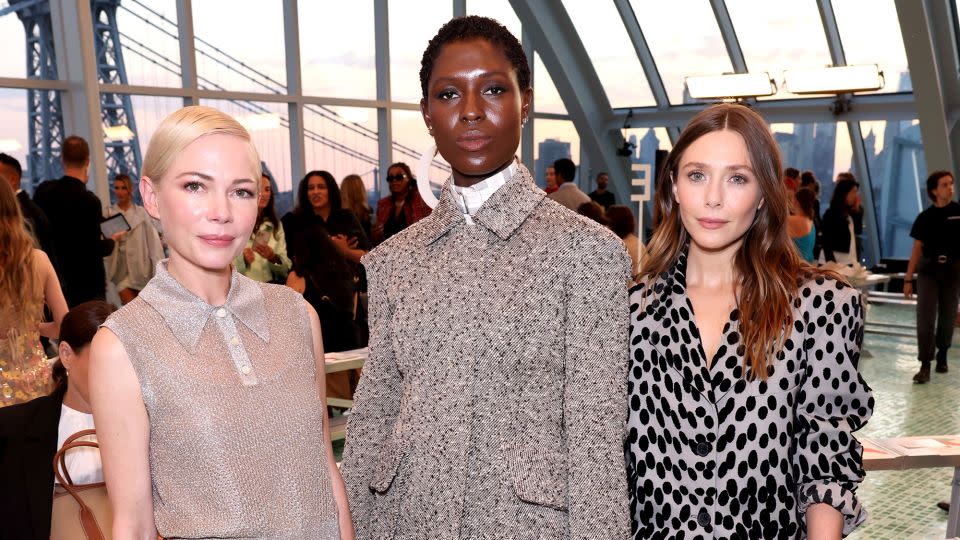 Michelle Williams, Jodie Turner-Smith and Elizabeth Olsen in the teal-tiled Brooklyn skylight where Tory Burch hosted her latest collection. - Jeff Schear/Getty Images