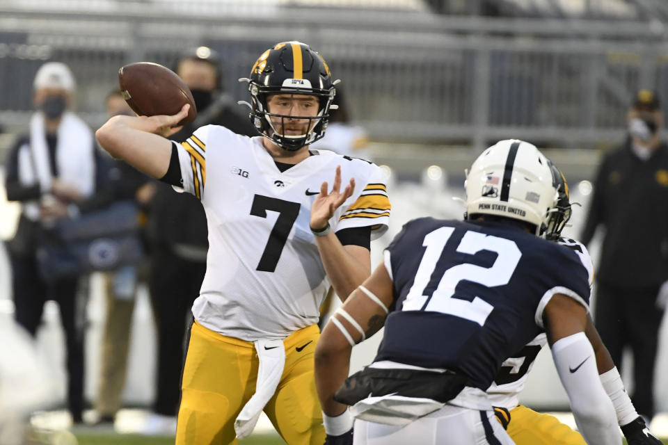 Iowa quarterback Spencer Petras (7) passes as Penn State linebacker Brandon Smith (12) pursues during the first quarter of an NCAA college football game in State College, Pa., on Saturday, Nov. 21, 2020. (AP Photo/Barry Reeger)