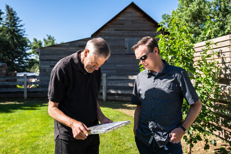 Former Colorado state climatologist Nolan Doesken, left, and current state climatologist Russ Schumacher take a look at a hail-measuring pad at Doesken's Fort Collins home on July 12. Doesken founded the Community Collaborative Rain, Hail and Snow Network, which has volunteers record and report daily precipitation, 25 years ago.