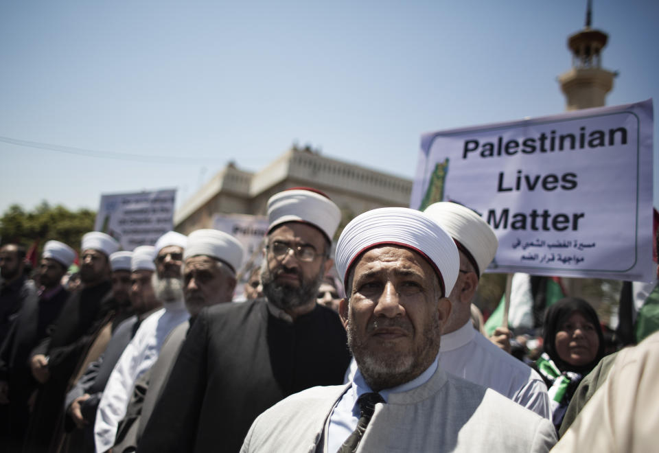 Palestinian Muslim clerics attend a demonstration against Israeli plans for the annexation of parts of the West Bank, in Gaza City, Wednesday, July 1, 2020. (AP Photo/Khalil Hamra)