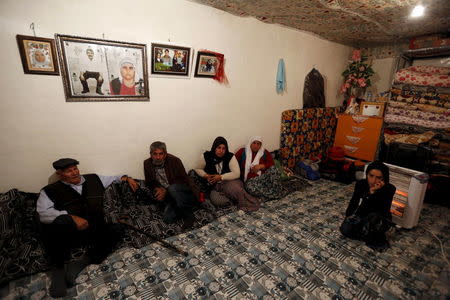 Sevgi Gezici (R), widow of Engin Gezici, sits next to her family members at their house in the southeastern town of Silvan in Diyarbakir province, Turkey, December 7, 2015. REUTERS/Murad Sezer