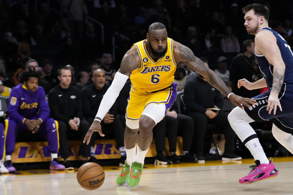 Los Angeles Lakers' LeBron James (6) drives past Dallas Mavericks' Luka Doncic during the first half of an NBA basketball game Thursday, Jan. 12, 2023, in Los Angeles. (AP Photo/Jae C. Hong)