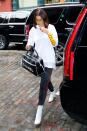 <p>In a white graphic tee with red leather striped Vetements jeans, Stuart Weitzman ankle boots, a Chanel duffel bag and yellow tinted aviator sunglasses while out in New York City.</p>