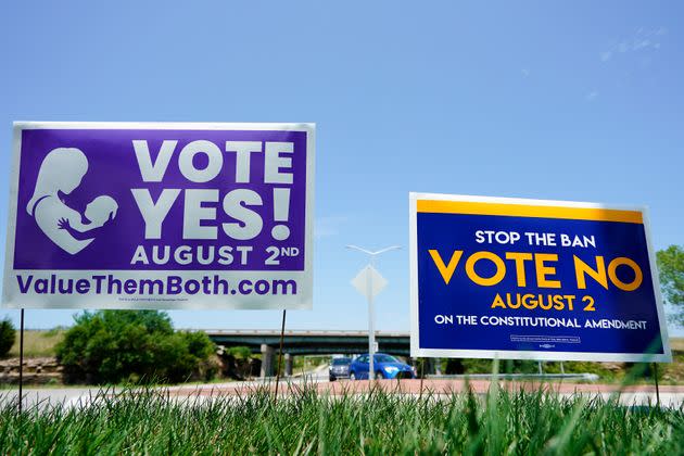 Signs for the opposing sides in the Aug. 2 Kansas vote on whether to restrict abortion rights were displayed outside Kansas 10 highway in Lenexa, Kansas. (Photo: Kyle Rivas via Getty Images)