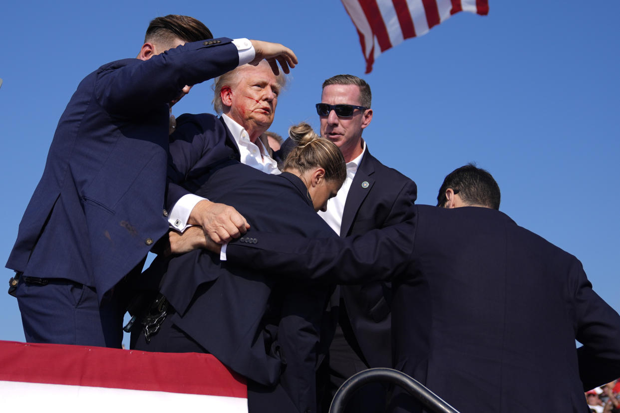 Republican presidential candidate former President Donald Trump is surround by Secret Service agents at a campaign rally on Saturday in Butler, Pa.