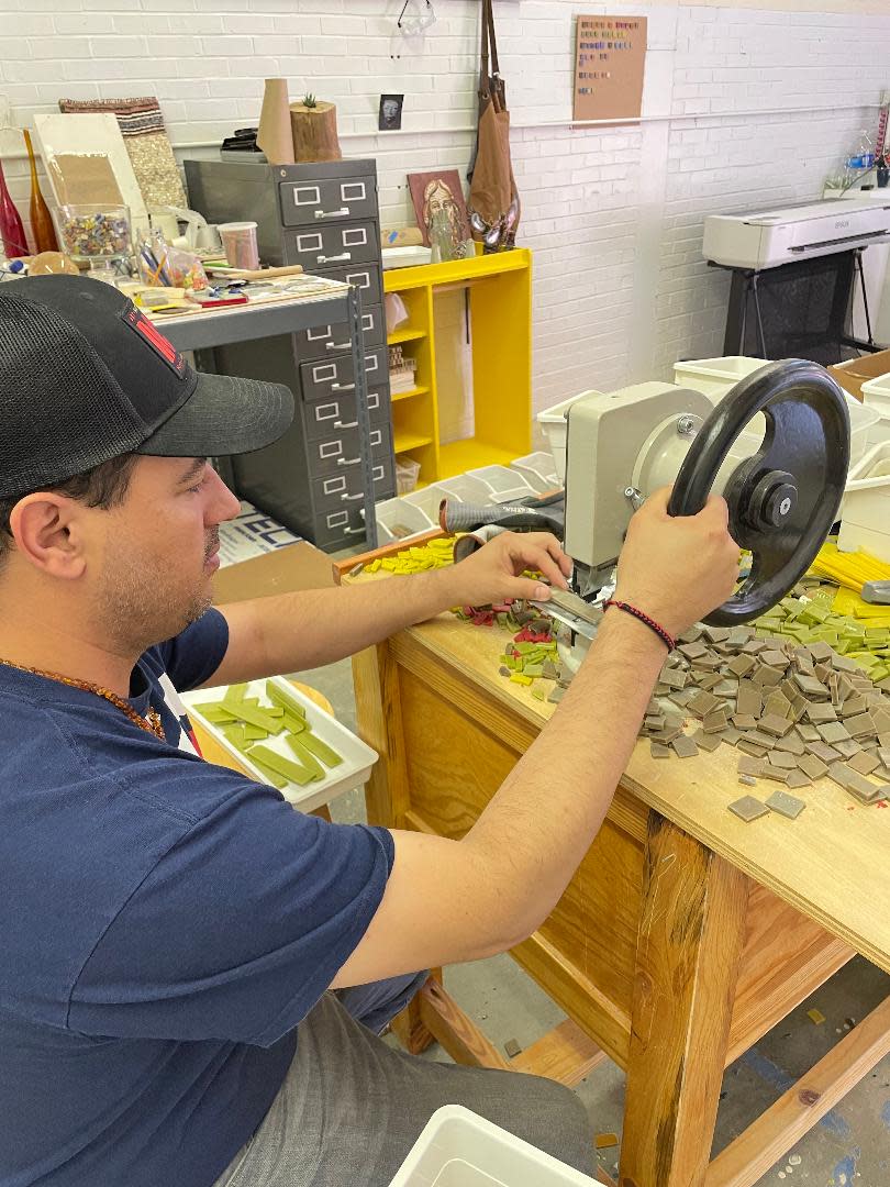 Carlos Gonzalez Garcia uses a machine from Turkey that quickly and easily breaks the tile for use in the mosaic.