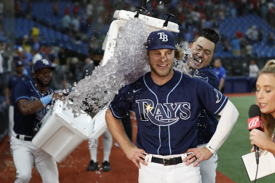 Tampa Bay Rays' Taylor Walls is showered with ice by teammates Ji-Man Choi, behind right, and Vidal Brujan after the team's baseball game against the St. Louis Cardinals on Tuesday, June 7, 2022, in St. Petersburg, Fla. (AP Photo/Scott Audette)