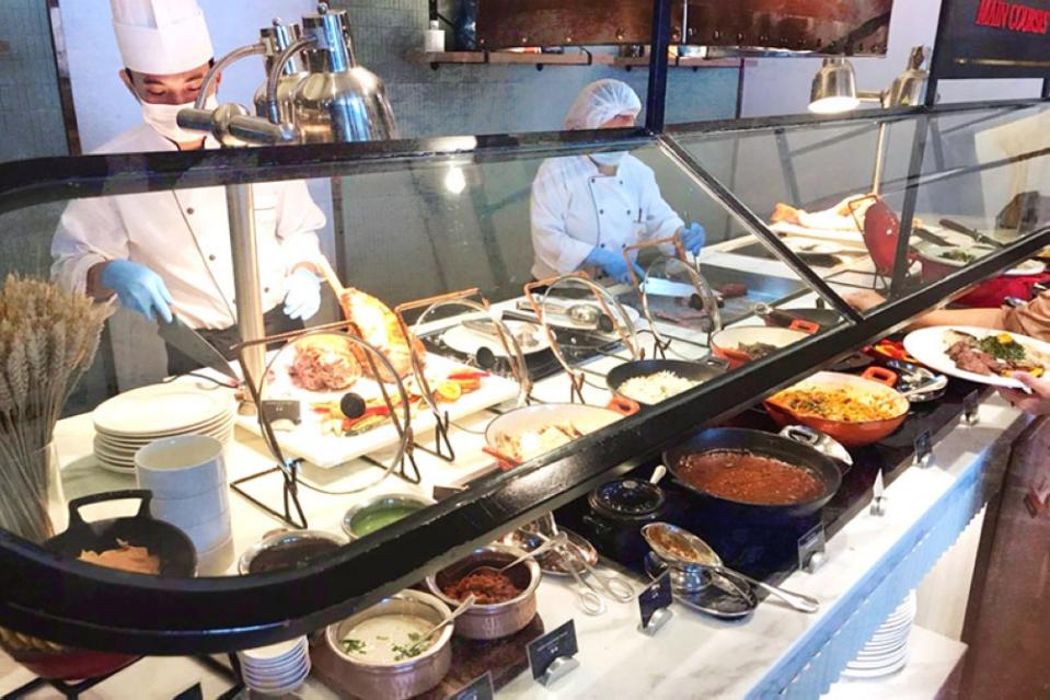 Chefs at their stations preparing food for hungry patrons.