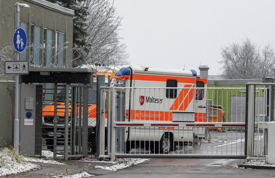A ambulance stands at Gate 1 of the airport Memmingen, Germany Friday, Nov. 26, 2021 . The German air force Luftwaffe will begin assisting the transfer of intensive care patients from hospitals in Bavaria to northern German states. (Peter Kneffel/dpa via AP)