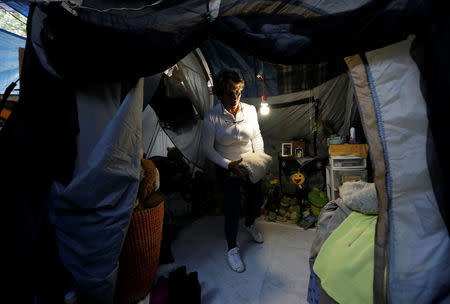 Maria Guadalupe Padilla is pictured inside her tent in the Tlalpan neighbourhood, near the site where her building was damaged by the devastating earthquake, that took place in Mexico City last year, Mexico, August 31, 2018. Picture taken August 31, 2018. REUTERS/Henry Romero