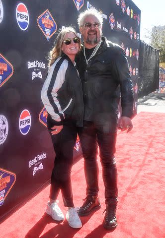 <p>Mindy Small/Getty</p> Guy Fieri and Lori Fieri at Super Bowl 2024.