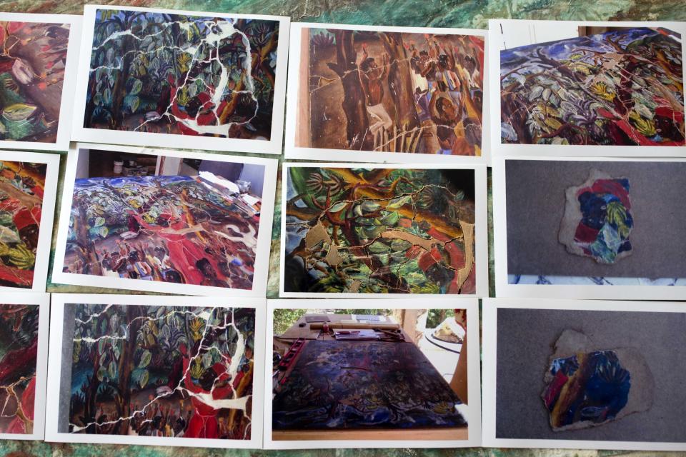 In this May 29, 2019 photo, photos of paintings damaged by the 2010 earthquake and needing restoration are displayed as a guide for renovators at the Musée d'Art du Collège Saint Pierre, in Port-au-Prince, Haiti. While life has begun anew for much of Haiti after the quake, the museum has been shuttered for nine years. ( AP Photo/Dieu Nalio Chery)