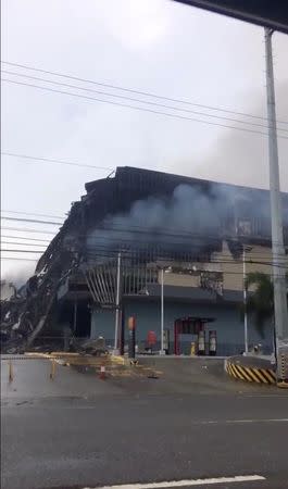 Smoke billows from a building the day after a fire broke out in Davao, the Philippines, in this still image taken a December 24, 2017 social media video. @JanellaBula/via REUTERS