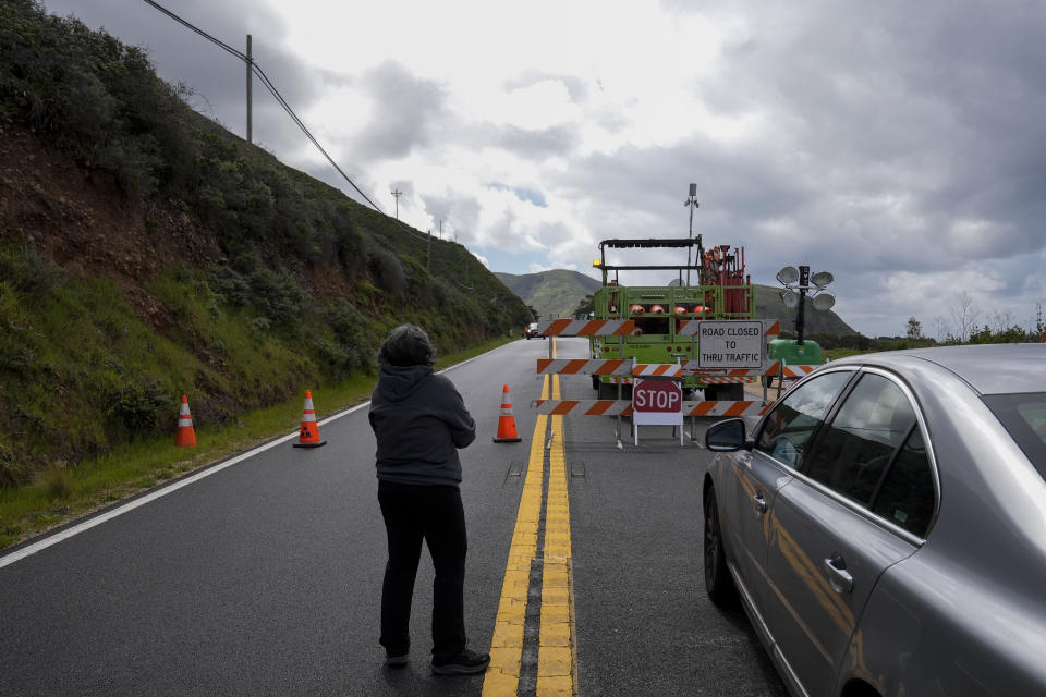 A motorist looks at a road closure on Highway 1 near Big Sur, Calif., Thursday, April 4, 2024. The closure was caused by a break in the southbound lane of Highway 1 at Rocky Creek Bridge. (AP Photo/Godofredo A. Vásquez)