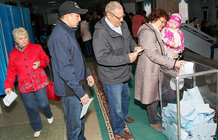 People cast their ballot at a polling station in Kazakhstan's capital Astana on April 26, 2015