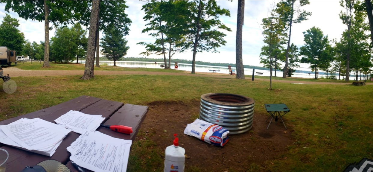 Teresa Weyer shows her campsite and work station or "traveling office," at Muskallonge State Park.