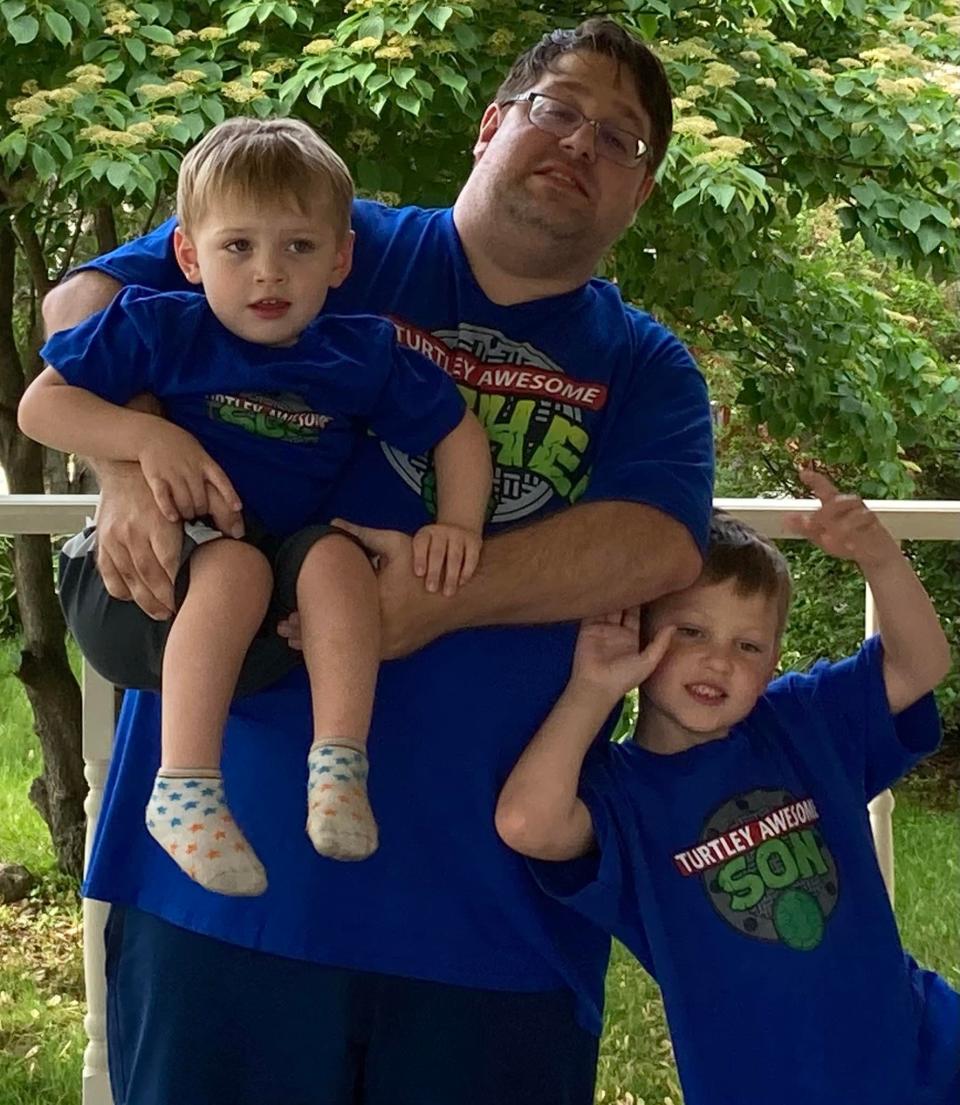 Sheboygan Press sports reporter Tom Dombeck poses with his sons Theo and Bryan, L-R, on Fathers Day wearing Teenage Mutant Ninja Turtles-themed shirts which say Turtley Awesome Son and Turtley Awesome Dad.