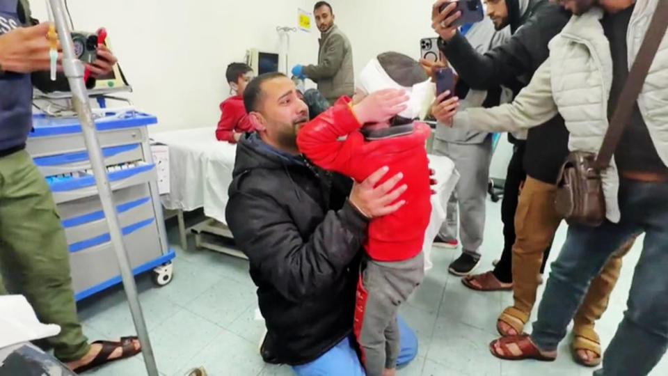 Palestinian doctor Dr. Rami Abu Libdeh holds his 9-year-old son, Mohammad, at a hospital in Rafah, Gaza, on Feb. 8, 2024. (NBC News)