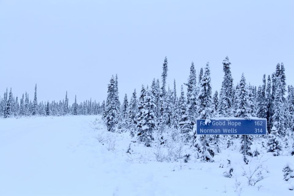 A sign showing distances from Colville Lake, N.W.T., on the Mackenzie Valley winter road, pictured in January 2020.
