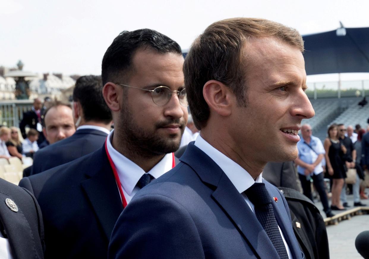 French President Emmanuel Macron walks ahead of his aide Alexandre Benalla at the end of the Bastille Day military parade in Paris: REUTERS