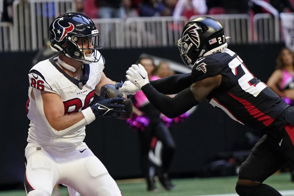 Houston Texans tight end Dalton Schultz (86) scores a touchdown against Atlanta Falcons safety Richie Grant (27) in the second half of an NFL football game in Atlanta, Sunday, Oct. 8, 2023. (AP Photo/Mike Stewart)