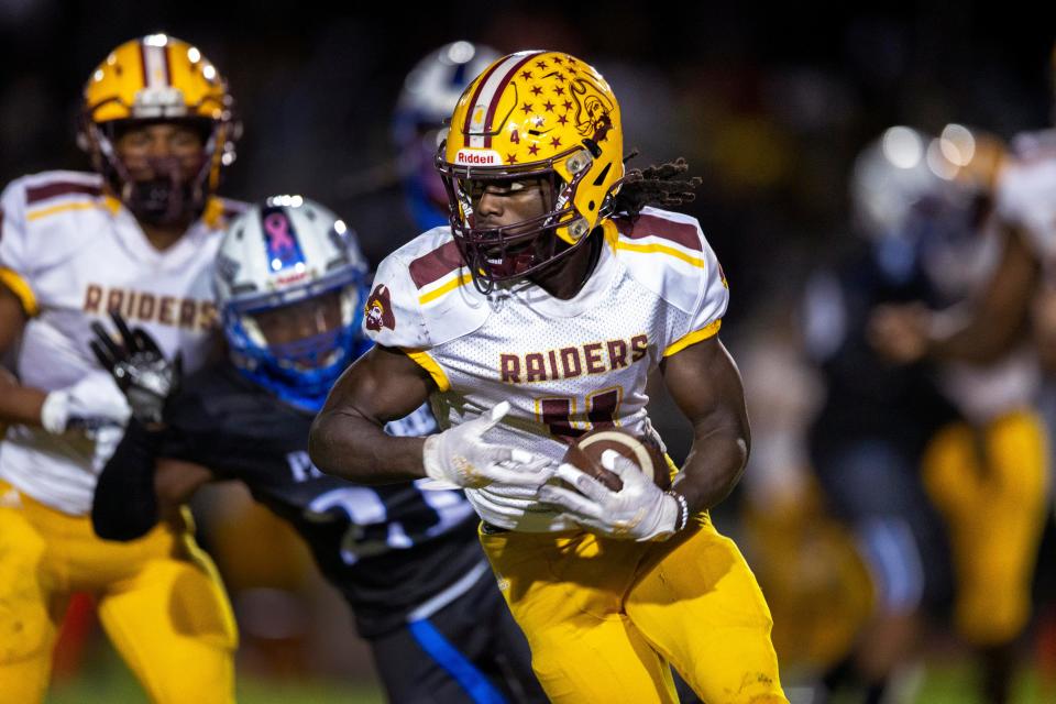 Glades Central running back Semaj Demps runs the ball against Pakokee during the Muck Bowl in Pahokee,  Florida on November 6, 2021.