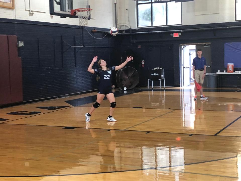 Veritas Christian volleyball setter Brooke Miller hits a serve over the net versus Reynolds Mountain Christian Academy.