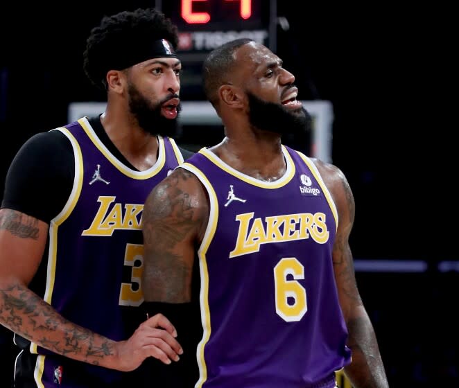 LOS ANGELES, CALIF. - OCT. 29, 2021. Lakers forward Anthony Davis talks with teammate LeBron James.