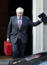 Britain's Prime Minister Boris Johnson leaves 10 Downing Street, London, Monday Sept. 21, 2020. Britain’s chief medical officers have raised the nation’s official COVID-19 alert level, meaning the virus is in general circulation and the transmission is high. Boris Johnson is expected to announce further curbs Tuesday to slow the spread of the virus. (Yui Mok/PA via AP)