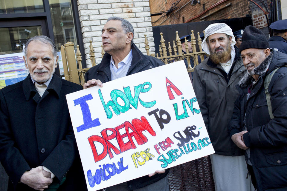 A man holds a sign that reads 