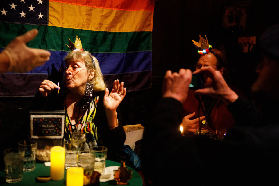 Bronwyn Rucker blows out the candle on her birthday cake during a celebration with friends at Julius'. (Julius Constantine Motal / NBC News)