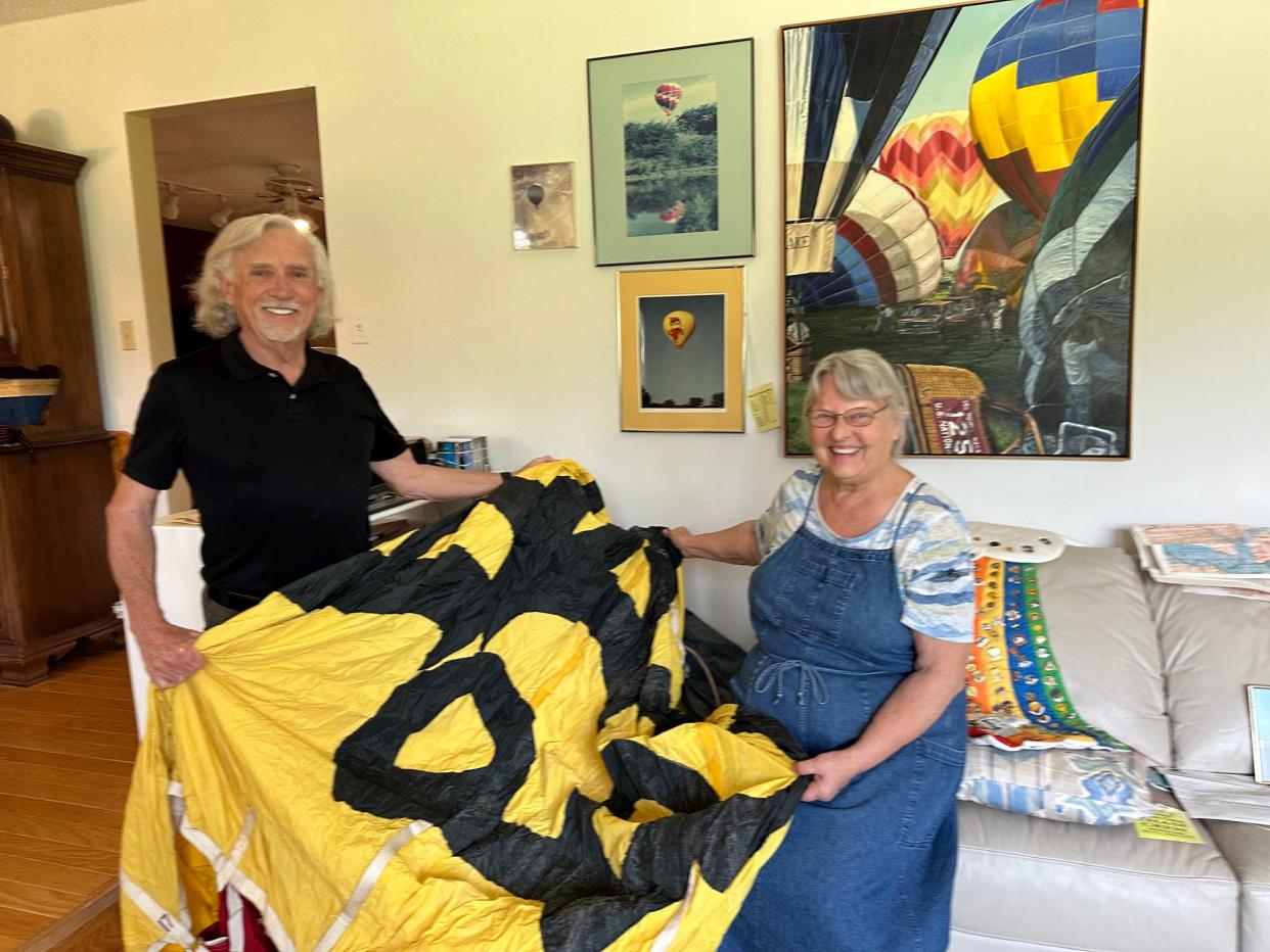 Bill and Toni Woodman currently keep their "Cy in the Sky" hot-air balloon in a special bag in the corner of the living room in their rural Ames home. "Most people do not have a balloon envelope in their living room," Bill said. The Woodmans are showing part of the 70-foot balloon that is Cy's foot.